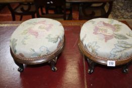 A pair of 19th Century mahogany foot stools with floral needlework seats on cabriole legs and a 19th