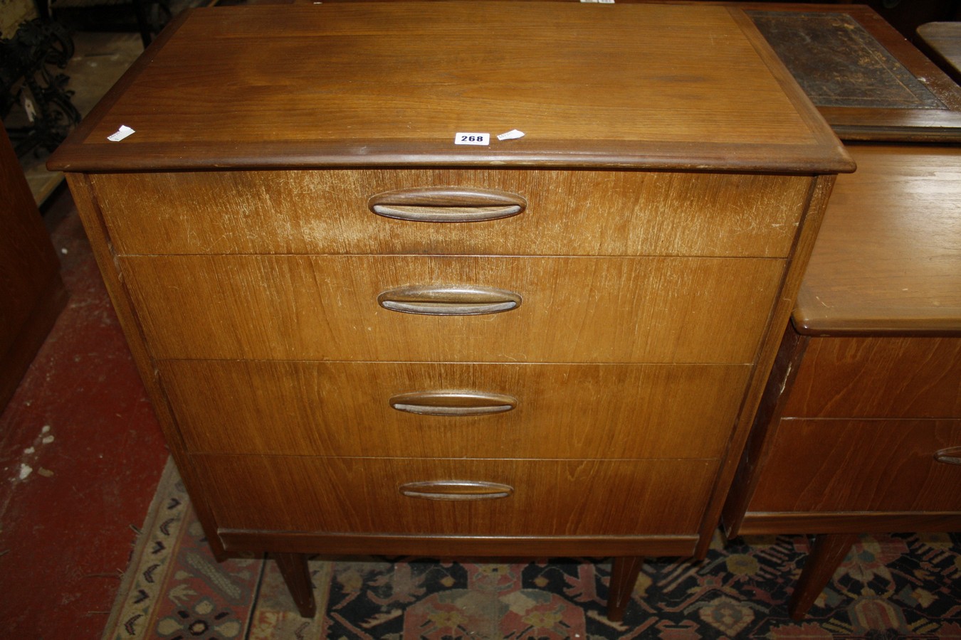 A teak bedroom suite to include a wardrobe, chest, sideboard, bedside table