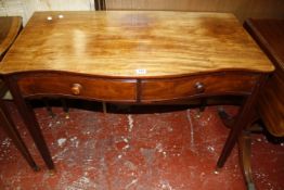 A George III mahogany serpentine side table with two frieze drawers 99cm wide