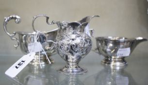 A silver cream jug, Birmingham, 1923 a gravy boat, Birmingham 1914 and a milk jug, 8.0 troy oz