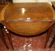 A George III mahogany and crossbanded oval pembroke table with a frieze drawer on square tapering