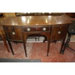 A George III style mahogany bowfront sideboard with a central drawer flanked by a cupboard and