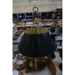 A brass bouillotte lamp.