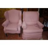 Two pink covered armchairs
