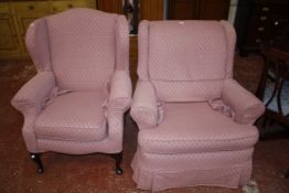 Two pink covered armchairs