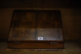 A Victorian walnut writing slope, a stationery rack, stationery box, bookrack and some leather bound