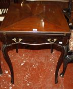 A late Victorian mahogany envelope card table with a frieze drawer on shaped legs 57cm high