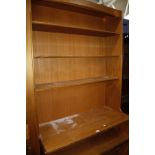 A teak open bookcase with lower panelled cupboard 103cm wide