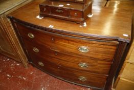 A late George III mahogany chest of drawers, circa 1800, of bowfront outline, the shaped top with