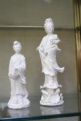 Two early 20th Century Blanc de Chine Guanyin figures, 23cm high and 16cm high (2)