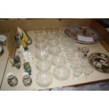 Ten etched glass finger bowls, twelve wine glasses, matching larger glasses and a pair of thistle