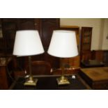 A pair of brass column table lamps (sold as parts
