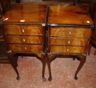 A pair of 19th Century style mahogany bedside tables each with three drawers on slender cabriole