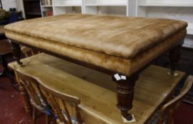 A William IV style upholstered stool on facetted legs 139cm wide