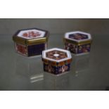 Three Royal Crown Derby hexagonal trinket boxes (A 1297 4cm wide, A 1295 5.5cm wide, A 1298, 5cm