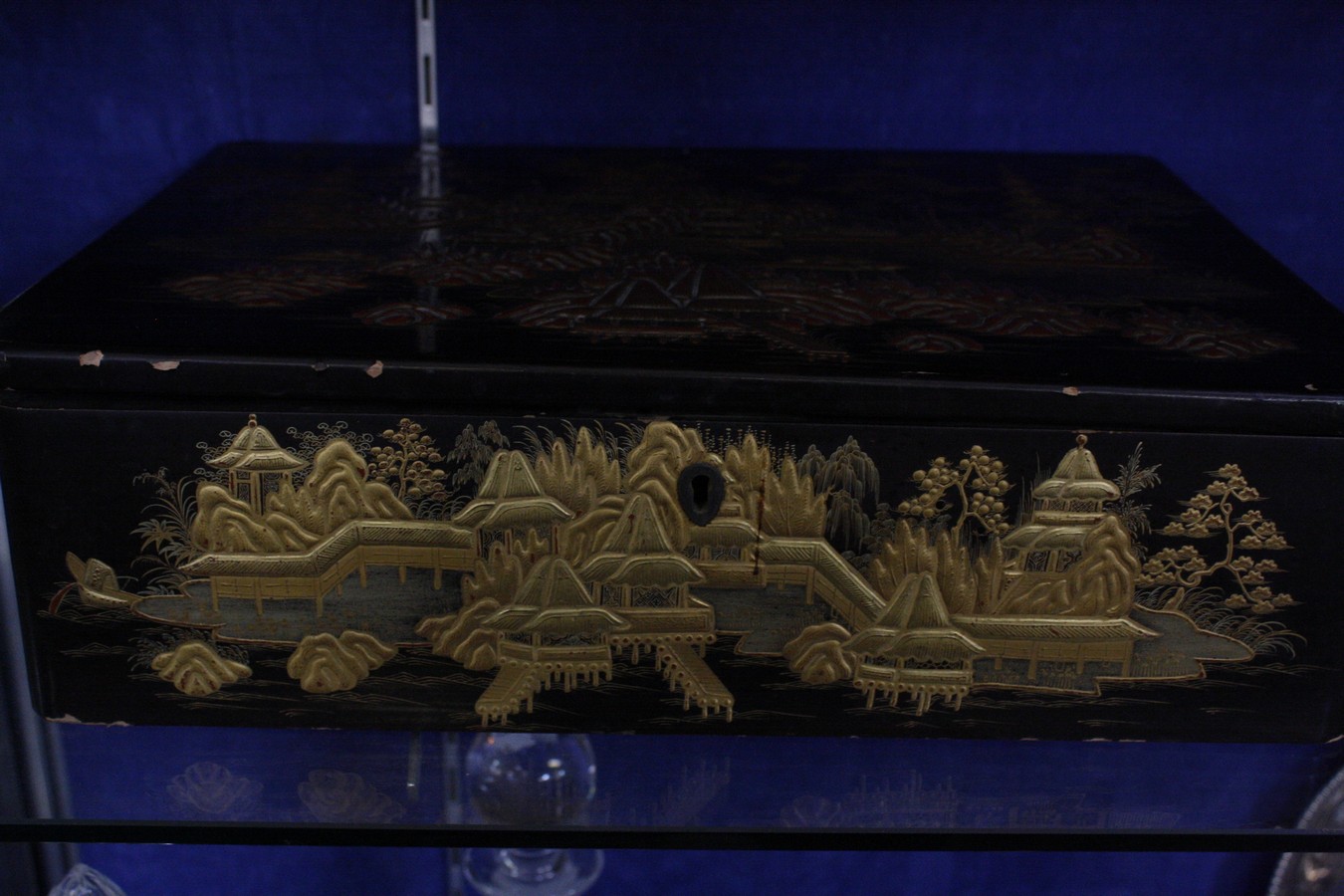 An early 19th century black lacquered work box, of rectangular form decorated with oriental