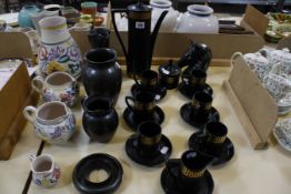 Four items of Poole Pottery; a Portmerion black and gilt part coffee set, two Prinknash pottery jugs