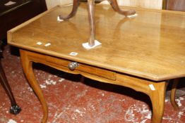 A French provincial walnut side table the moulded edged top with canted angles, with a frieze drawer