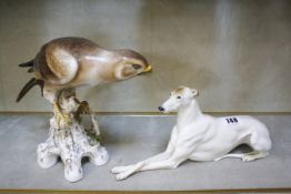 A Capodimonte model of a hawk, 18cm high and a porcelain hound (damaged) (2)