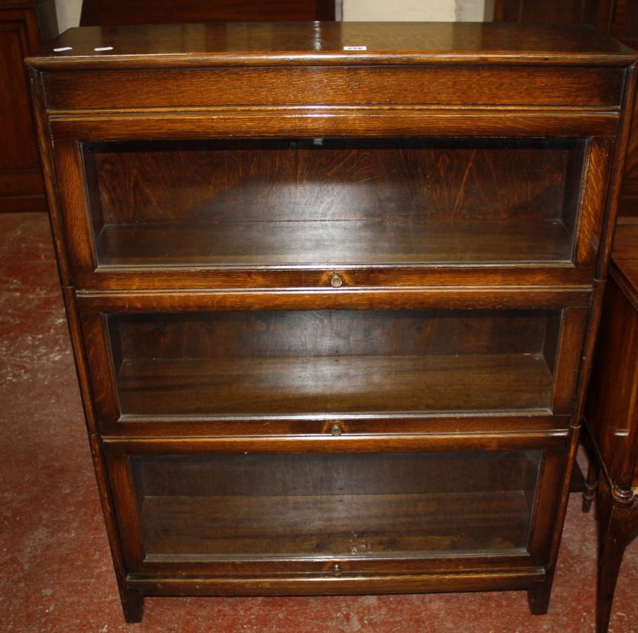 A Gunn oak three-section glazed bookcase bearing inscription