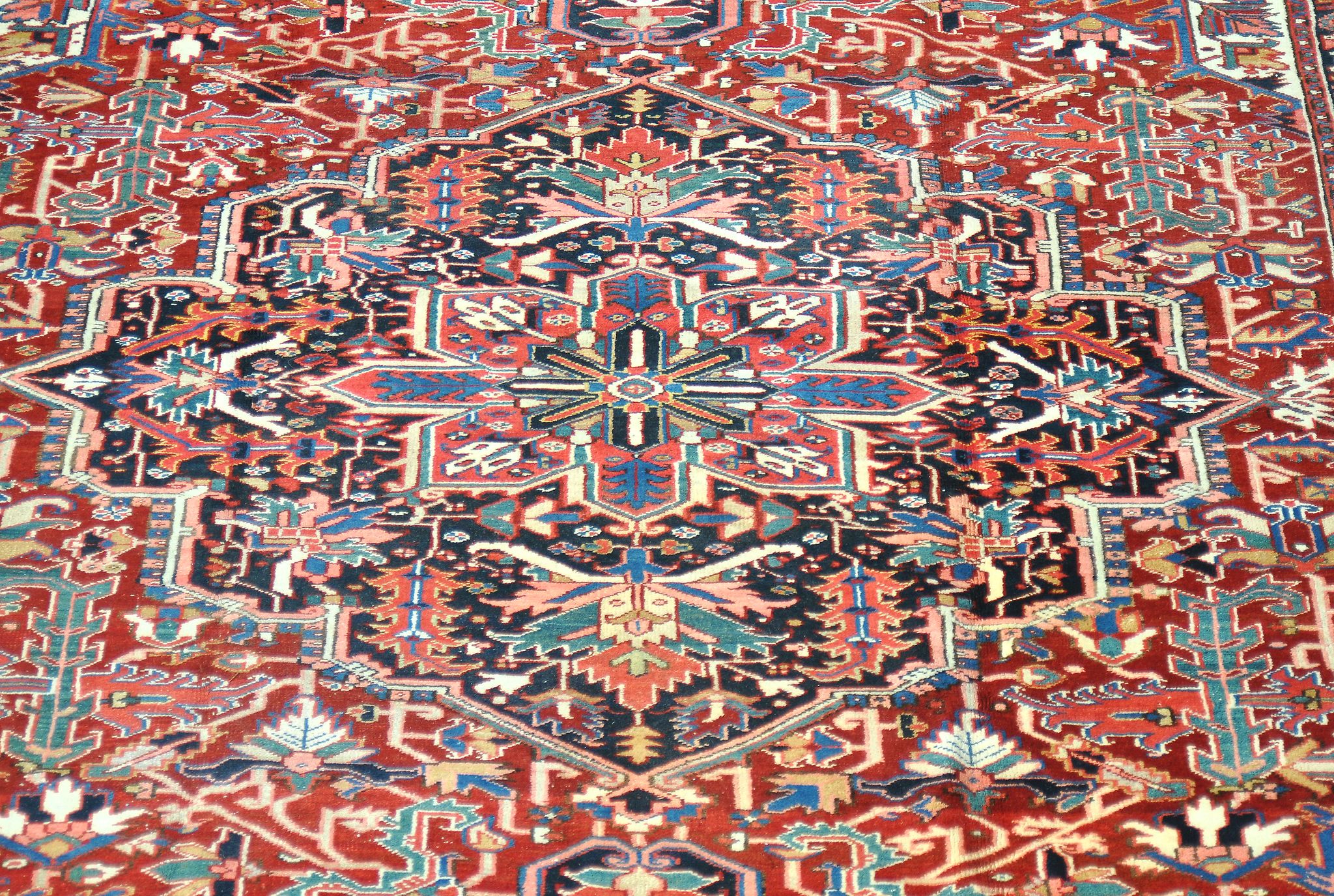 A Heriz carpet,   decorated with abstracted foliate motifs throughout, the central navy medallion - Image 2 of 2