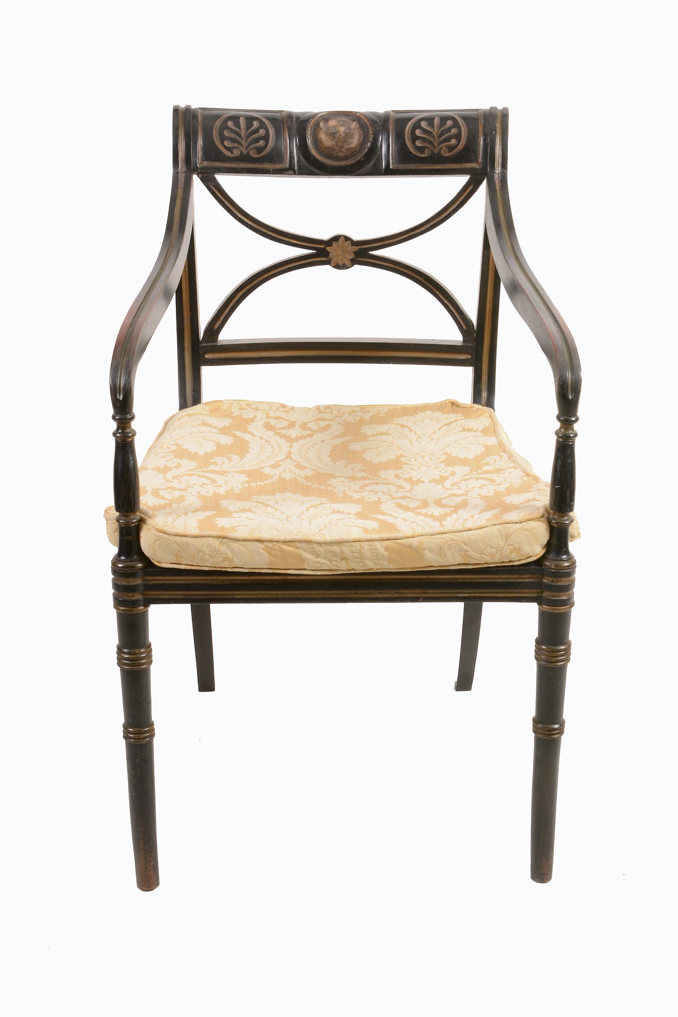 A George III ebonised and painted armchair, circa 1800, the shaped rectangular back with dresting