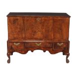 A burr walnut chest on stand  , circa 1735 and later, the hinged top with moulded edge opening to