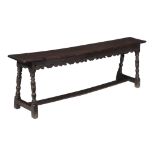 A Charles I oak long stool or bench  , circa 1630, the rectangular seat with moulded edge above a