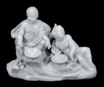 A North Italian porcelain group of two supplicant putti  , late 18th century, modelled before a