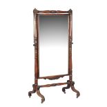 A Regency mahogany and gilt metal mounted cheval mirror,   circa 1815, the rectangular mirror plate