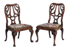 A pair of George II walnut chairs, circa 1735, attributed to Giles Grendey,   each cartouche shaped