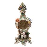 A Meissen flower-encrusted clock case and movement,   late 19th century, the scrolling base with a