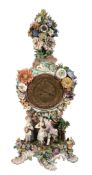 A Meissen flower-encrusted clock case and movement,   late 19th century, the scrolling base with a