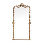 A Victorian giltwood and composition wall mirror,   circa 1860,   the shaped rectangular plate