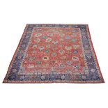 A Tabriz carpet,   of overall design, the madder field decorated with large flowerheads and
