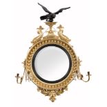 A Regency giltwood convex girandole wall mirror,   circa 1815, the circular plate within the
