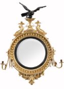 A Regency giltwood convex girandole wall mirror,   circa 1815, the circular plate within the