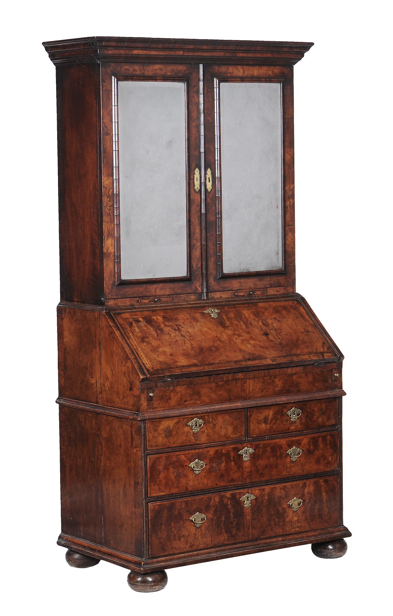 A George II walnut bureau bookcase  , circa 1735, the moulded cornice above a pair of bevelled