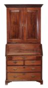 A George II mahogany bureau bookcase,   circa 1750, the moulded cornice with dentil frieze above a