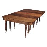 A Regency mahogany concertina action extending dining table  , circa 1815, with five additional