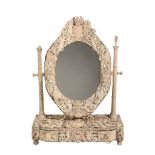 A French carved bone and ivory dressing table mirror , Dieppe, mid 19th century, the oval plate