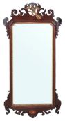 A George III mahogany wall mirror  , circa 1770,  the top with pierced and carved motif centred by