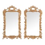 A pair of George III carved giltwood wall mirrors,   circa 1770, each shaped rectangular plate