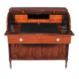 A George III mahogany tambour desk  , circa 1790, the tambour fall opening to a pair of tambour