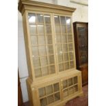 A George III style pine glazed bookcase 228cm high, 141cm wide
