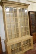 A George III style pine glazed bookcase 228cm high, 141cm wide