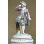 A 20th Century porcelain figure of a man in a pink frock coat (damaged), 18cm high