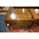 A mahogany pembroke table with a shaped top above a cupboard 76cm wide