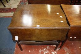 A mahogany pembroke table with a shaped top above a cupboard 76cm wide