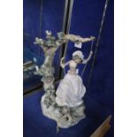 A Lladro figure of a girl swinging from a tree, 38cm high (af)